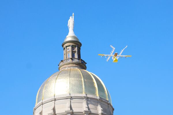 A drone from Wing, a delivery company, is seen flying beside the Gold Dome during a demonstration for lawmakers at Liberty Plaza on Tuesday in Atlanta.