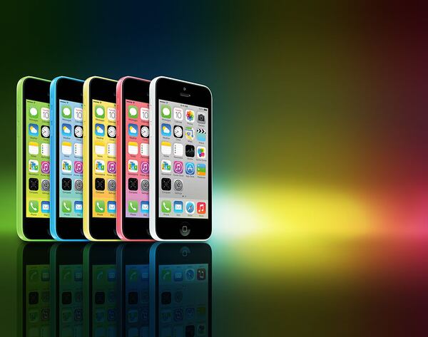 A row of different coloured Apple iPhone 5C smartphones photographed on a rainbow background, taken on September 20, 2013. (Photo by Joby Sessions/MacFormat Magazine via Getty Images)