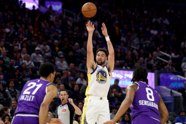 FILE - Golden State Warriors guard Klay Thompson (11) shoots against Utah Jazz forward's Darius Bazley (21) and Brice Sensabaugh (8) during the first half of an NBA basketball game in San Francisco, April 14, 2024. (AP Photo/Jed Jacobsohn, File)