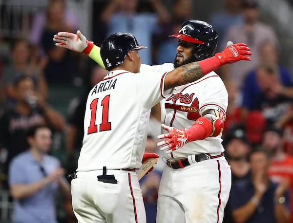 Braves designated hitter Marcell Ozuna gets a hug from Orlando Arcia after hitting a solo homer to take a 10-1 lead over the Philadelphia Phillies during the seventh inning of a MLB baseball game on Tuesday, August 2, 2022, in Atlanta.   “Curtis Compton / Curtis Compton@ajc.com