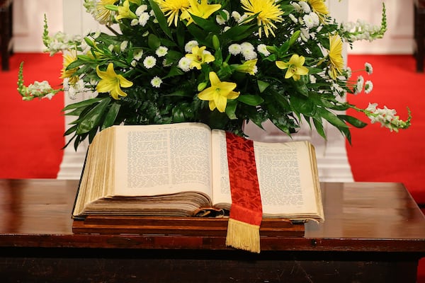 The Holy Bible sits on the communion table during the Palm Sunday service at Second-Ponce De Leon Baptist Church in this AJC file photo. (Curtis Compton / ccompton@ajc.com)