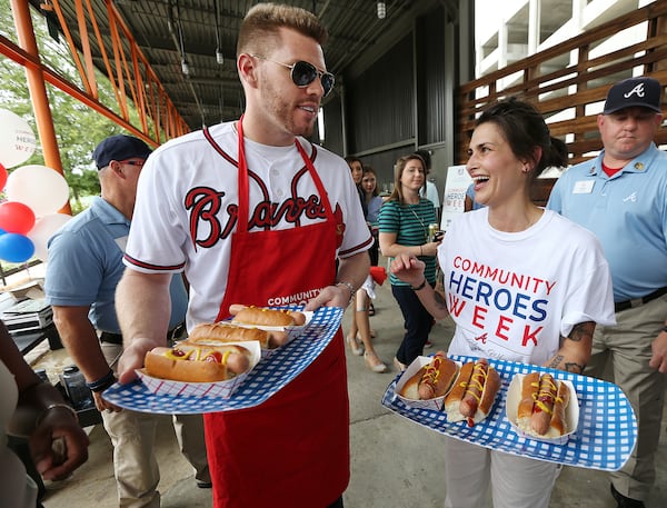 June 19, 2017, Atlanta: Jen Hidinger of Staplehouse and The Giving Kitchen and Atlanta Braves first baseman Freddie Freeman hand out free hot dogs to the community as she is honored as a Braves Community Hero at the Ponce City Market along the beltline on Monday, June 19, 2017, in Atlanta.    Curtis Compton/ccompton@ajc.com