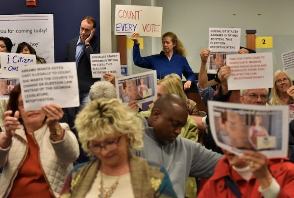 Groups on both sides of the voter access issue crowded into the Gwinnett County Board of Elections meeting on Tuesday afternoon. HYOSUB SHIN / HSHIN@AJC.COM