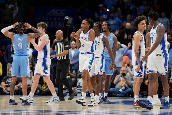 Duke celebrates a lane violation call in the final seconds against North Carolina during an NCAA college basketball game in the semifinals of the Atlantic Coast Conference tournament, Friday, March 14, 2025, in Charlotte, N.C. (AP Photo/Chris Carlson)