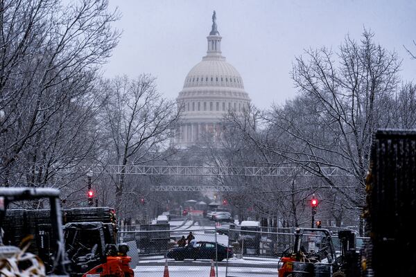 Snow falls on the Capitol in Washington, Sunday, Jan. 19, 2025. (AP Photo/J. Scott Applewhite)