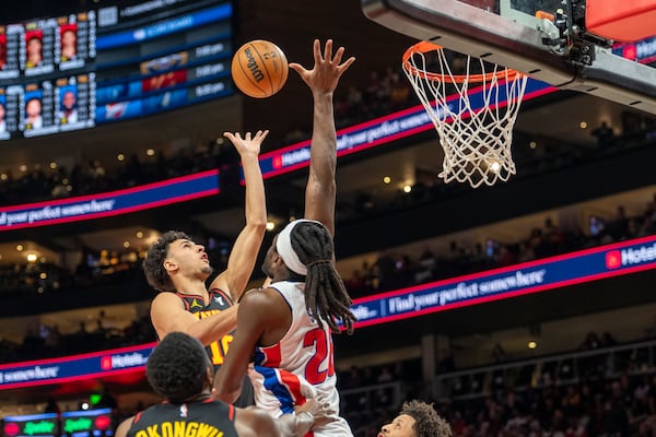 Atlanta Hawks forward Zaccharie Risacher, upper left, attempts a basket during the first half of an NBA basketball game against the Detroit Pistons, Sunday, Feb. 23, 2025, in Atlanta. (AP Photo/Erik Rank)