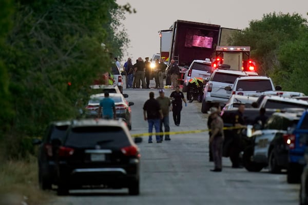 FILE - Police and other first responders work the scene where officials say dozens of people have been found dead and multiple others were taken to hospitals with heat-related illnesses after a tractor-trailer containing suspected migrants was found on June 27, 2022, in San Antonio, Texas. (AP Photo/Eric Gay, File)