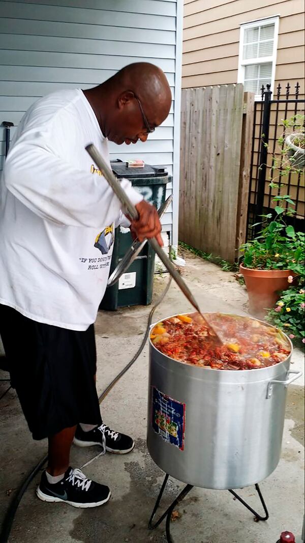 This undated photo provided by the family of Cornell Charles shows him boiling crawfish. In a city ravaged by the coronavirus outbreak, Zulu and its members have paid a heavy price. Charles is one Zulu member who died. His wife, Nicole, said her husband was a longtime coach with kids and was drawn to Zulu’s philanthropic mission.