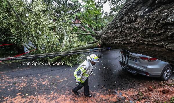 Deputy Chief Vera Morrison walks along Drexel Avenue in Decatur, where a  tree landed on two homes.