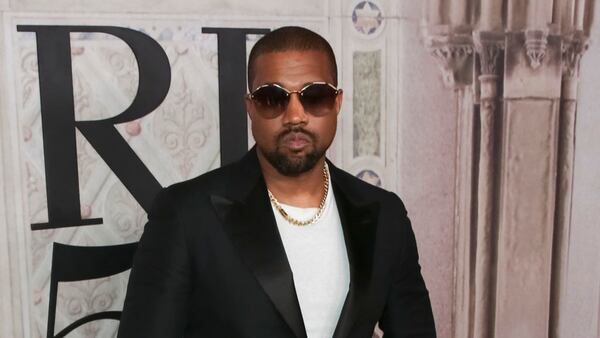 FILE- In this Sept. 7, 2018, file photo Kanye West attends the Ralph Lauren 50th Anniversary Event held at Bethesda Terrace in Central Park during New York Fashion Week in New York. President Donald Trump has panned Saturday Night Live's season premiere but tweeted praise for Kanye West. As the show ended, West took the stage wearing a "Make America Great Again" hat and made an unscripted pro-Trump speech after the credits rolled. (Photo by Brent N. Clarke/Invision/AP, File)