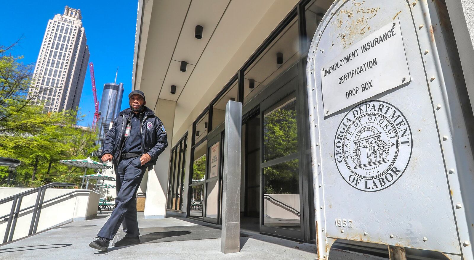 A security guard walks past the unemployment certification drop box in front of the Georgia Department of Labor. Jobless claims have skyrocketed since the COVID-19 pandemic  shut down businesses across the state and country, with Georgia’s claims filed in a three-week period surpassing figures from the peak of the Great Recession. JOHN SPINK / JSPINK@AJC.COM