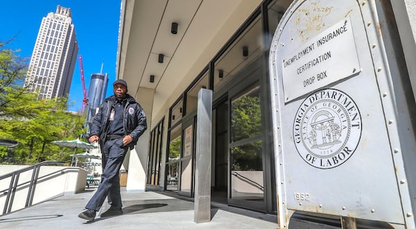 A security guard walks past the unemployment certification drop box in front of the Georgia Department of Labor. Jobless claims have skyrocketed since the COVID-19 pandemic  shut down businesses across the state and country, with Georgia’s claims filed in a three-week period surpassing figures from the peak of the Great Recession. JOHN SPINK / JSPINK@AJC.COM