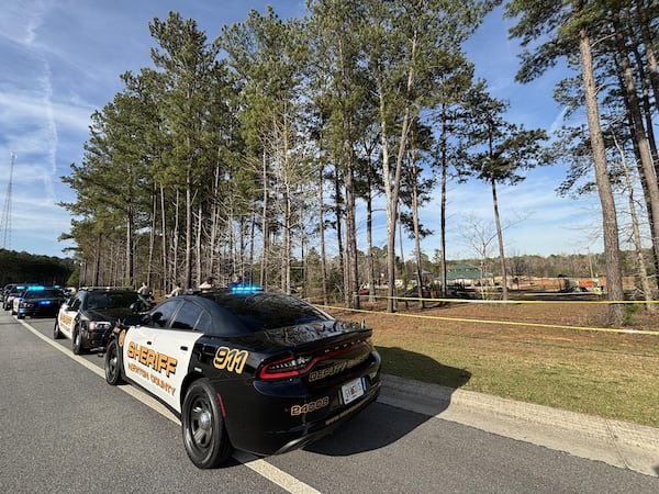 Newton County Sheriff's Office deputies investigate a fatal shooting at Denny Dobbs Park.