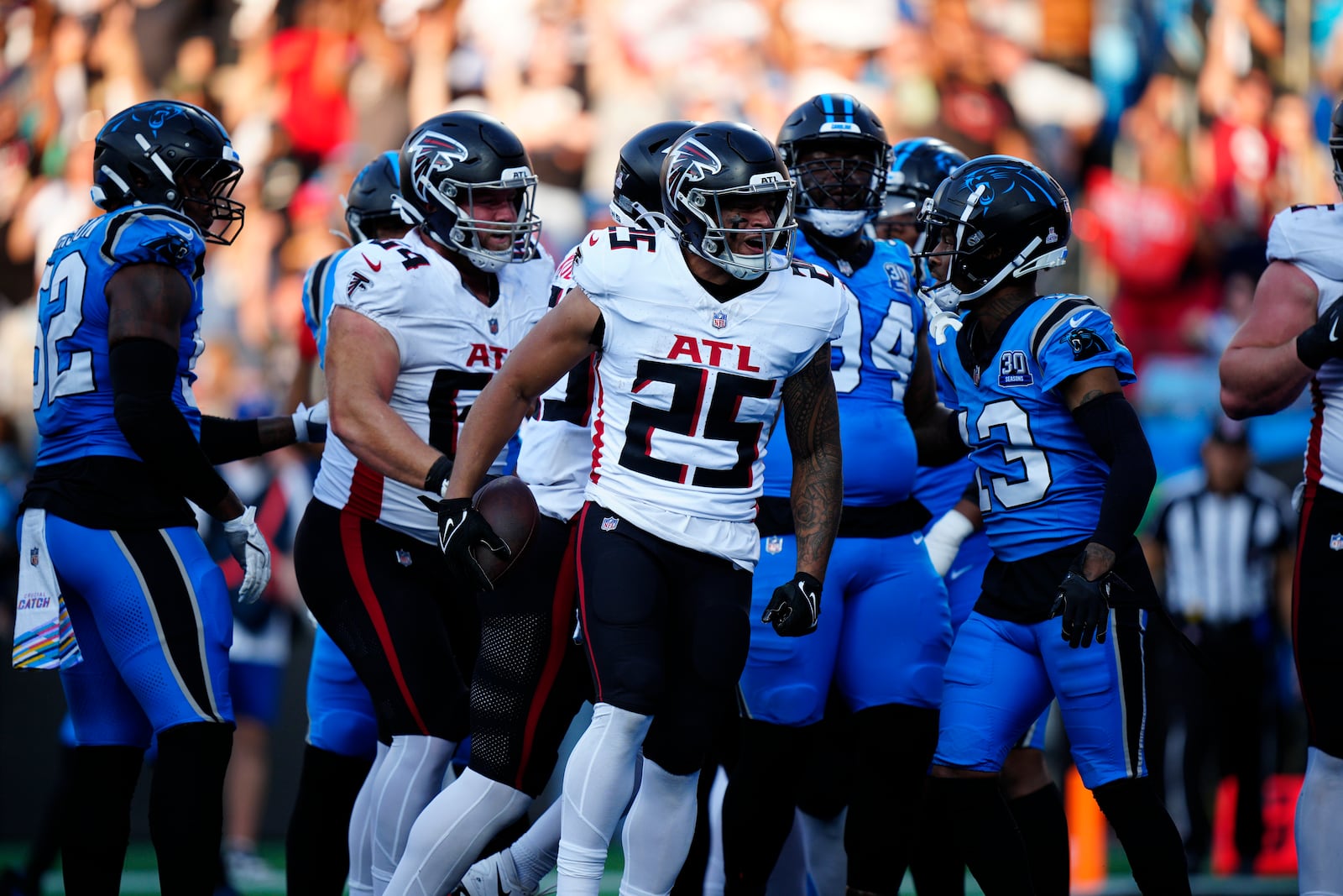 Atlanta Falcons running back Tyler Allgeier (25) celebrates after running in a a 2-point conversion in the first half of an NFL football game against the Carolina Panthers in Charlotte, N.C., Sunday, Oct. 13, 2024. (AP Photo/Jacob Kupferman)