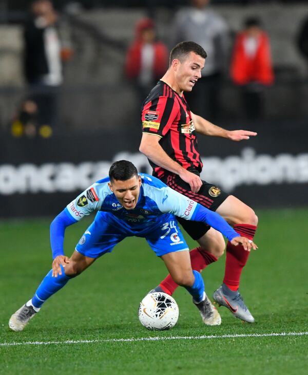 Motagua FCâs Kevin Lopez and Atlanta United defender Brooks Lennon, rear, battle for control of the ball during the first half of soccer in the Scotiabank Concacaf Champions League, Tuesday, Feb. 25, 2020, in Kennesaw, Ga. (John Amis, Atlanta Journal Constitution)