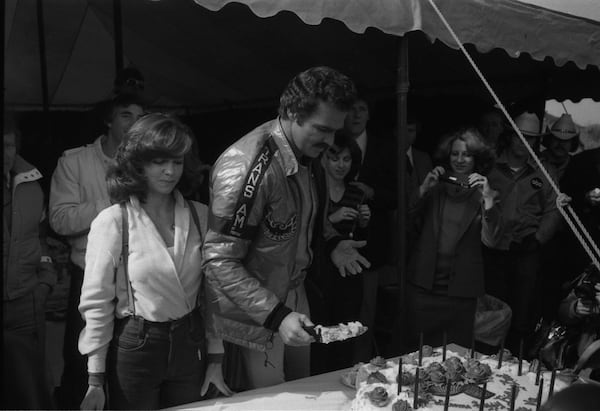 Burt Reynolds' birthday was Feb. 11. On that day in 1980 he was filming "Smokey and the Bandit II" in Atlanta so he and Sally Field and others on the set enjoyed a celebration with birthday cake. AJC archive photo: Jerome McClendon