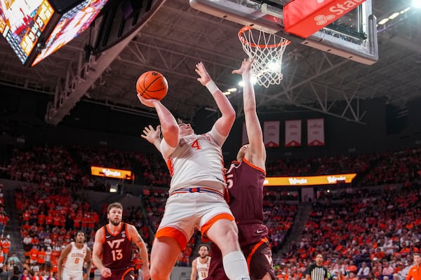 Clemson forward Ian Schieffelin (4) attempts a shot over a Virginia Tech defender during the second half of an NCAA college basketball game Saturday, March 8, 2025, in Clemson, S.C. (AP Photo/David Yeazell)