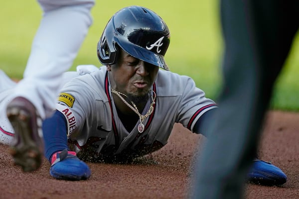 Atlanta Braves' Ozzie Albies slides into third base against the Cleveland Guardians, advancing from first on a hit by Austin Riley during the third inning of a baseball game Wednesday, July 5, 2023, in Cleveland. (AP Photo/Sue Ogrocki)