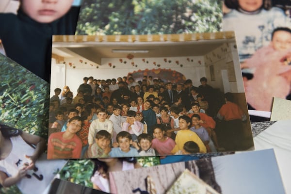 A photograph of the children at Katalina Jones’ orphanage in Romania rests on a table in Gainesville on May 5. Jones and her sister Amy Damera fared better than most in Romania’s orphanages, which were known for awful conditions during the reign of dictator Nicolae Ceausescu. DAVID BARNES / DAVID.BARNES@AJC.COM