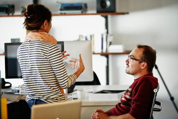 A man listens to a woman talking