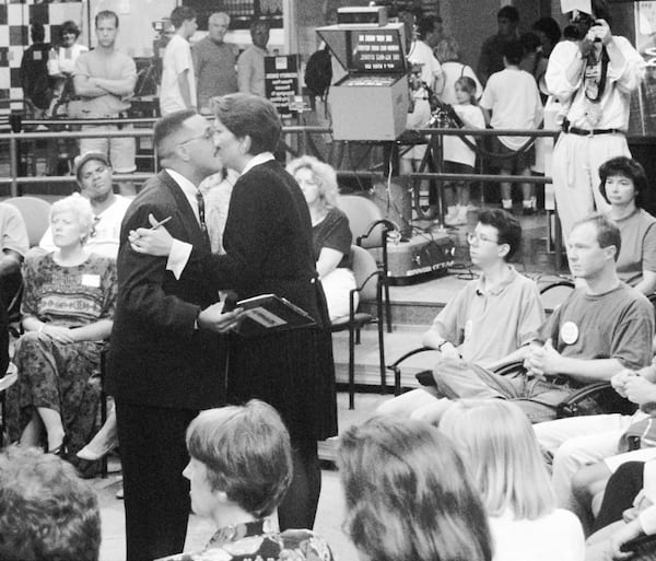 TalkBack Live host Susan Rook whispers last-minute instructions to 'co-host' Eric Parker in an AJC file photo from the mid-1990s. AJC FILE PHOTO