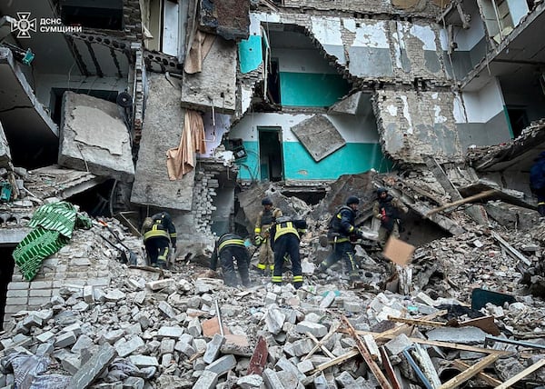 In this photo provided by the Ukrainian Emergency Services on Nov. 19, 2024, rescue workers clear the rubble of a residential building destroyed by a Russian strike in Hlukhiv, Ukraine. (Ukrainian Emergency Service via AP)