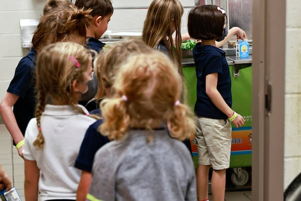 Students at Burgess-Peterson Academy in Atlanta wait in line for their lunches on Thursday, Aug. 4, 2022. The school is one of 20 sites in Atlanta Public Schools where families must once again submit applications to qualify for free or reduced-price school meals. (Natrice Miller/natrice.miller@ajc.com)