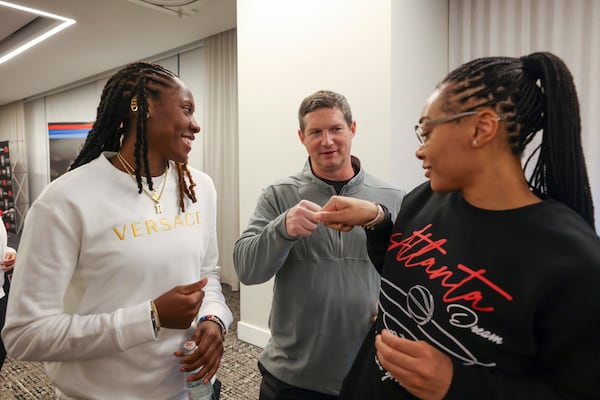 Atlanta Dream coach Karl Smesko, center, greets Atlanta Dream players Rhyne Howard, left, and Allisha Gray after his introductory press conference at Signia by Hilton Atlanta, Tuesday, November 19, 2024, in Atlanta. (Jason Getz / AJC)