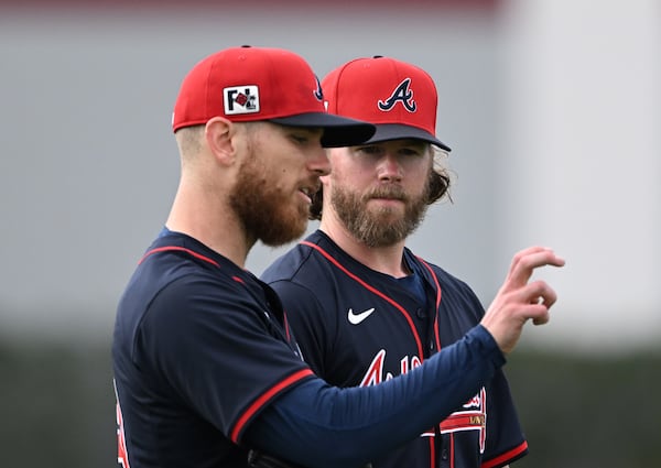 Braves pitcher Chad Kuhl (left) chats with Pierce Johnson during a recent spring training workout.