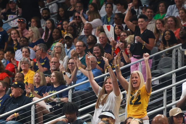 Fans of Indiana Fever guard Caitlin Clark react after she made a three-point basket during the second half against the Atlanta Dream at State Farm Arena, Friday, June 21, 2024, in Atlanta. Indiana won 91-79. (Jason Getz / AJC)
