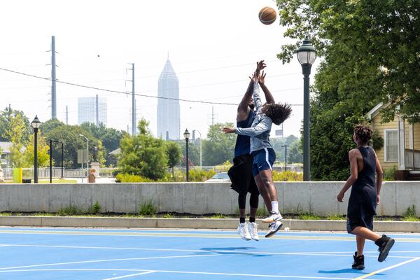 (L-R) Carlos, of West Lake, Isis Thorpe, of Vine City, and Landyn Harris, of Loganville, play basketball in the Vine City neighborhood of Atlanta on Tuesday, July 18, 2023. (Arvin Temkar / arvin.temkar@ajc.com)