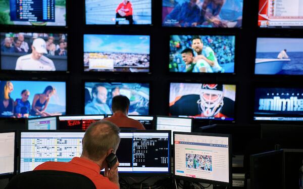 Trader Scott Logan works at William Hill, an international sports betting book, in Las Vegas, June 26, 2018. Now that the United States has ended a ban on sports betting, should the gambling industry be required to use league-approved "official data?" (Bridget Bennett/The New York Times)