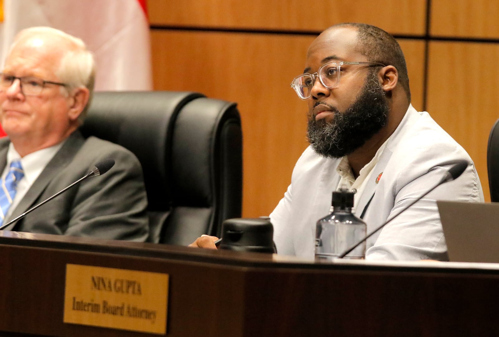 Board member Leroy "Tre'" Hutchins watches public commenters speak during a Cobb County School Board meeting in Marietta on Thursday, July 15, 2021. This school board meeting was the first full meeting to allow the public in to view without restrictions since February 2020. (Christine Tannous / christine.tannous@ajc.com)