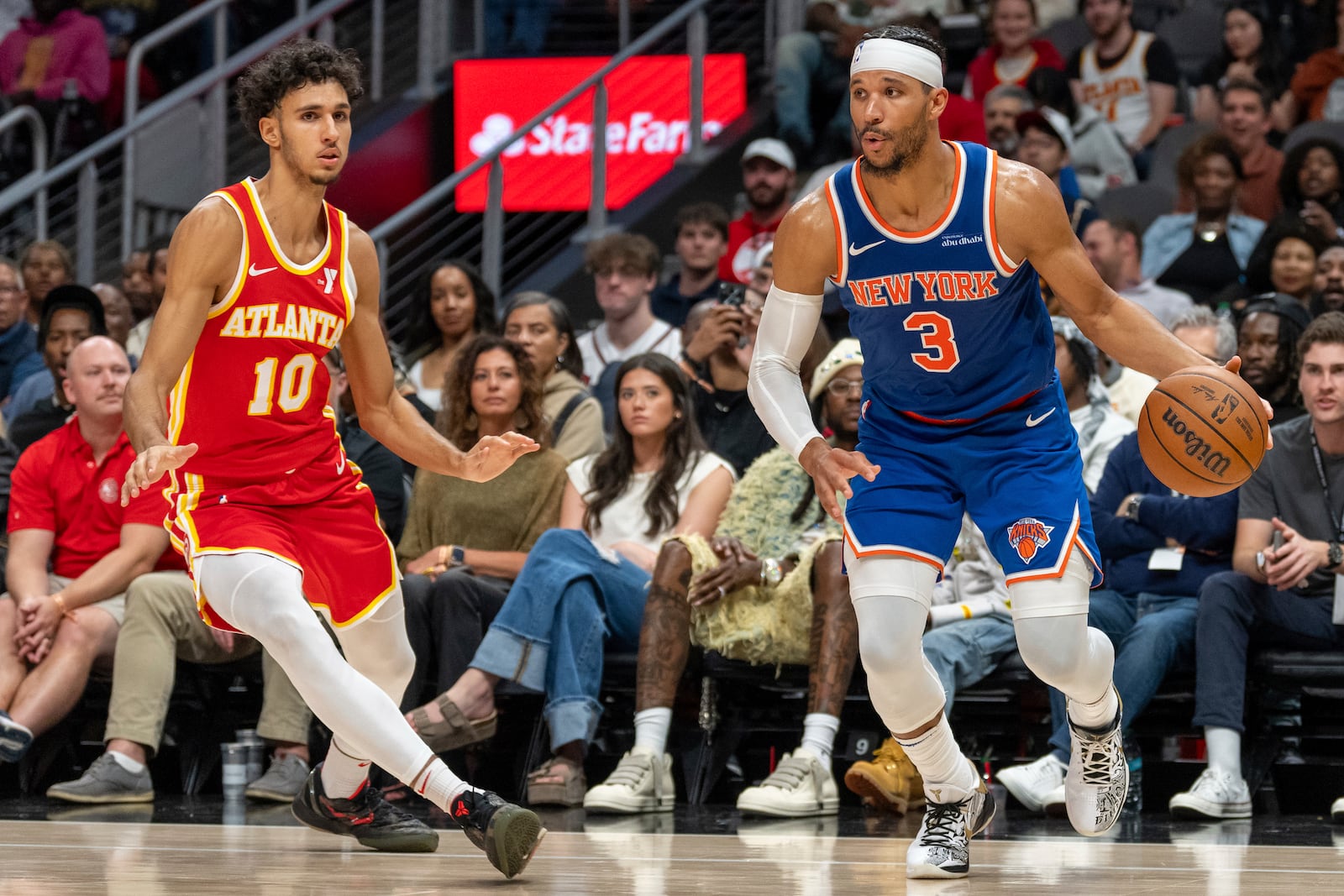 New York Knicks guard Josh Hart (3) dribbles around Atlanta Hawks forward Zaccharie Risacher (10) during the second half of an NBA basketball game, Wednesday, Nov. 6, 2024, in Atlanta. (AP Photo/Jason Allen)