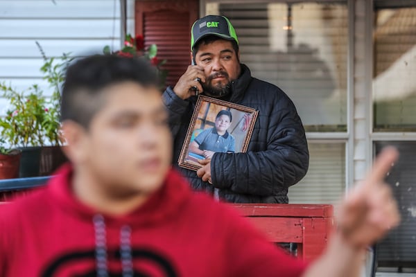 October 16, 2020 Clayton County: Santiago Zavala (center) holds a photo of his slain 13-year old son Brayan on Friday, Oct. 16, 2020 as Jesus Zavala (left) said he had no warning before his 13-year-old brother was shot and killed in front of him Thursday night in their front yard in Clayton County. The two were working on a lawn mower outside their home on Willow Lane, located in a mobile home community off Ga. 85 outside Riverdale. The elder brother barely noticed when a Chevrolet HHR pulled up to his neighbor’s house and a man climbed out, he said. “The shooter didn’t even say I want your money, or this is a robbery or I’m assaulting you,” Zavala, 16, told The Atlanta Journal-Constitution from outside his home on Friday. “He just came, stood there (in) silence and shot my brother. Just for killing.” Brayan Zavala was dead when Clayton County police officers arrived about 9:15 p.m. The Kendrick Middle School student was not a troublemaker, his brother said. He was a typical kid who spent most days with his family since the start of the coronavirus pandemic. Work, then home. Homework, then rest.
A Clayton County police spokesman on Thursday said investigators have yet to determine a connection between Brayan and the gunman. Investigators collected evidence at the mobile home park community overnight and declined to provide more information at the scene, Channel 2 Action News reported. The family has started a GoFundMe fundraiser to take Brayan’s body back to Mexico to be buried. (John Spink / John.Spink@ajc.com)

