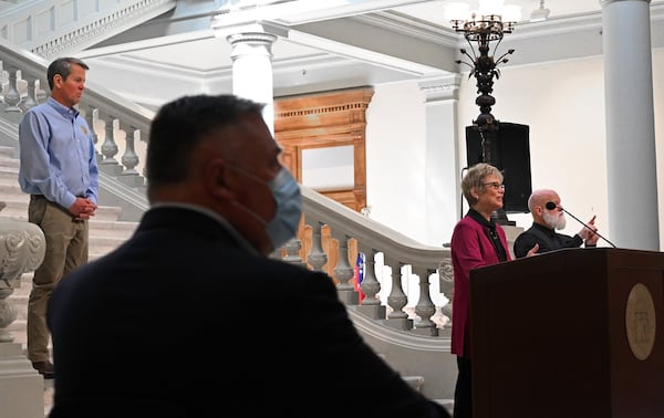 Dr. Kathleen Toomey, commissioner of Georgia Department of Public Health, speaks as Gov. Brian Kemp looks during a press briefing to update on COVID-19 at the Georgia State Capitol on Tuesday, May 12, 2020. HYOSUB SHIN / HYOSUB.SHIN@AJC.COM