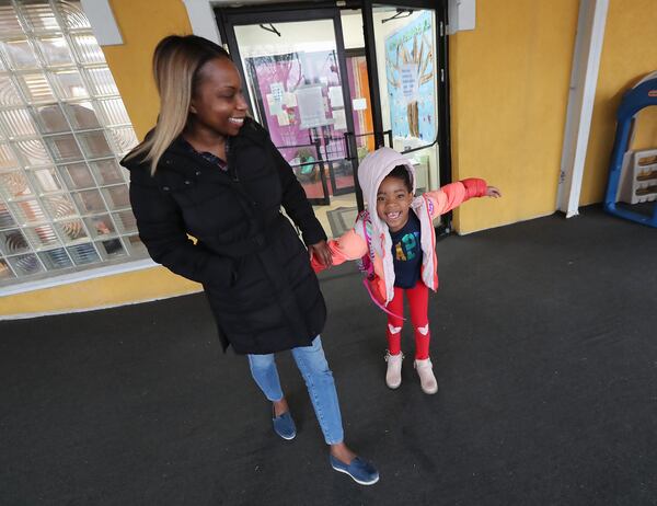 Rabiah Morning-Parker picks her daughter Ayana, 7, up at Genesis Early Learning & Child Development Center on Thursday, Jan. 21, 2021, in Atlanta. Morning-Parker is an Atlanta Public School teacher who has returned to the classroom before her daughter’s school has restarted in-classroom learning. Curtis Compton / Curtis.Compton@ajc.com