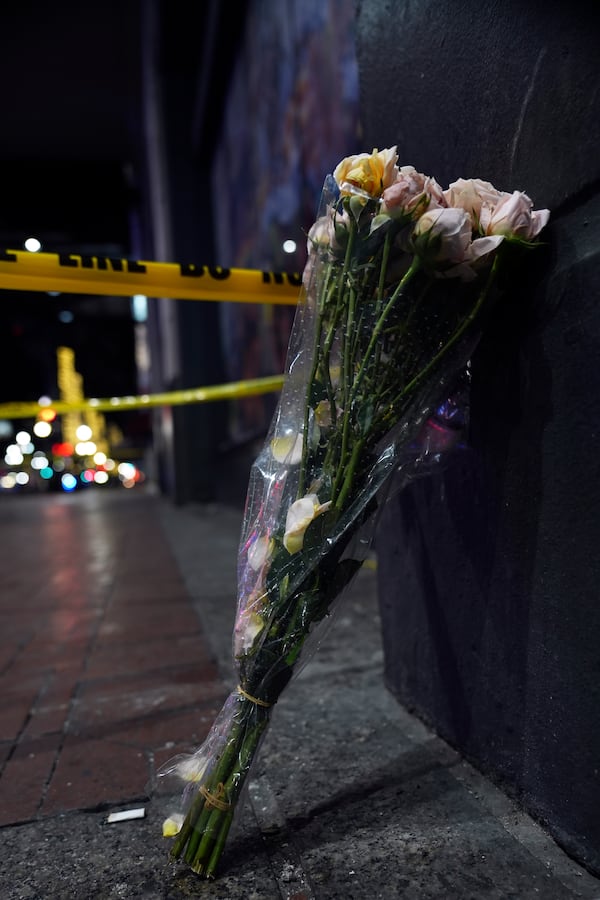 Flowers are seen near where a vehicle drove into a crowd on New Orleans' Canal and Bourbon streets, Wednesday, Jan. 1, 2025. (AP Photo/George Walker IV)