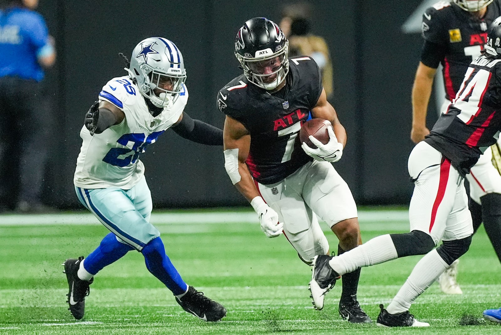 Atlanta Falcons running back Bijan Robinson (7) carries past Dallas Cowboys safety Malik Hooker (28) during the second half of an NFL football game, Sunday, Nov. 3, 2024, in Atlanta. (AP Photo/ John Bazemore)