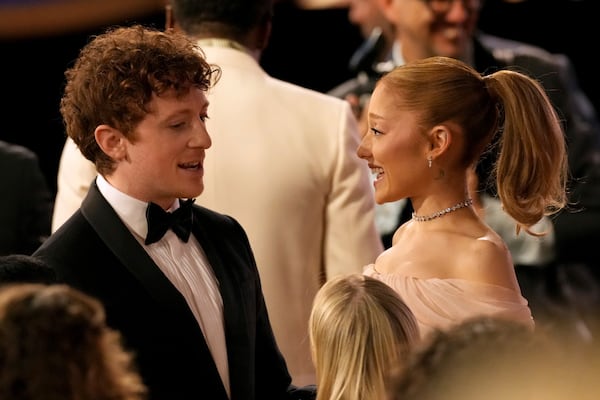 Ethan Slater, left, talks with Ariana Grande during the 31st annual Screen Actors Guild Awards on Sunday, Feb. 23, 2025, at the Shrine Auditorium in Los Angeles. (AP Photo/Chris Pizzello)