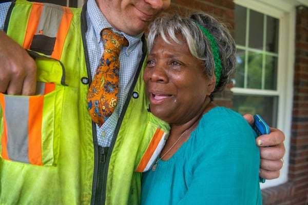 Dorothy Williams, who was displaced from her home in 2021, hugs an inspector on Thursday, July 18, 2024 during a tour of recent renovations made to the house.  (Ziyu Julian Zhu / AJC)