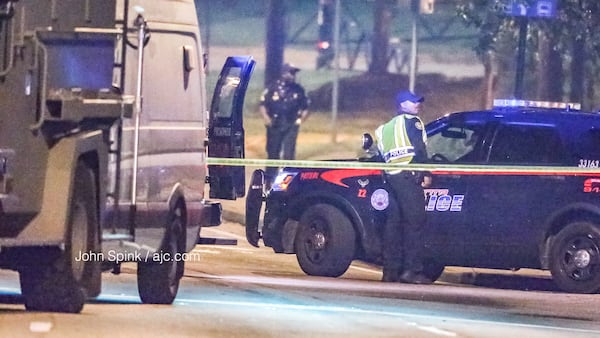 A SWAT standoff started on Lee Street early Friday after an armed man got into an argument with a woman. JOHN SPINK / JSPINK@AJC.COM