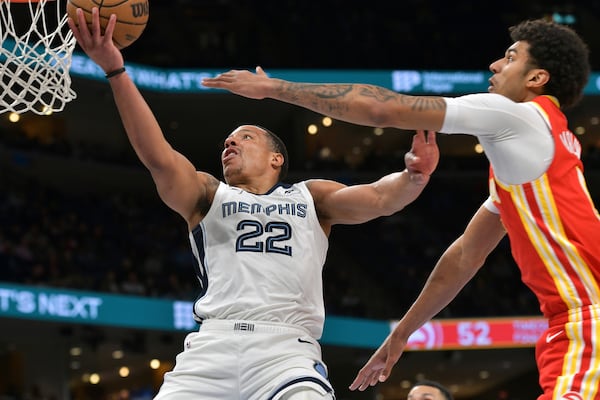 Memphis Grizzlies guard Desmond Bane (22) shoots against Atlanta Hawks forward Dominick Barlow, right, in the first half of an NBA basketball game Monday, March 3, 2025, in Memphis, Tenn. (AP Photo/Brandon Dill)