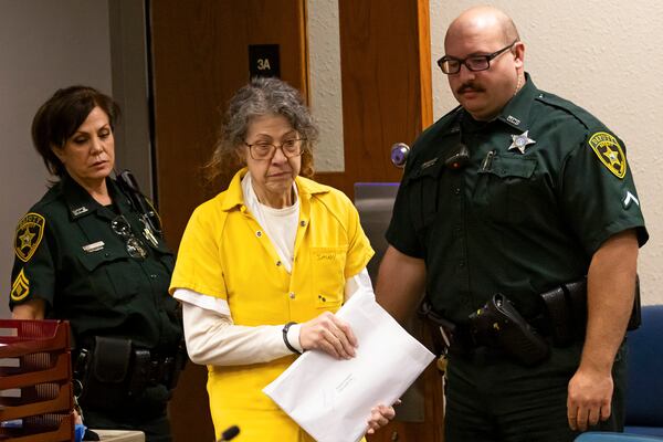 Susan Lorincz, center, who fatally shot a Black neighbor through her front door during an ongoing dispute, enters the courtroom for her sentencing hearing Monday, Nov. 25, 2024, in Ocala, Fla. (Doug Engle/Ocala Star-Banner via AP, Pool)