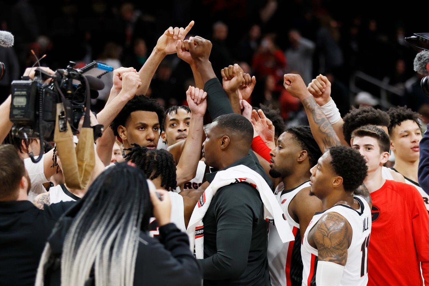 Bulldogs players and coaches gather in the center of the floor to celebrate their 77-62 victory against the Fighting Irish on Sunday night at State Farm Arena. (Miguel Martinez / miguel.martinezjimenez@ajc.com)