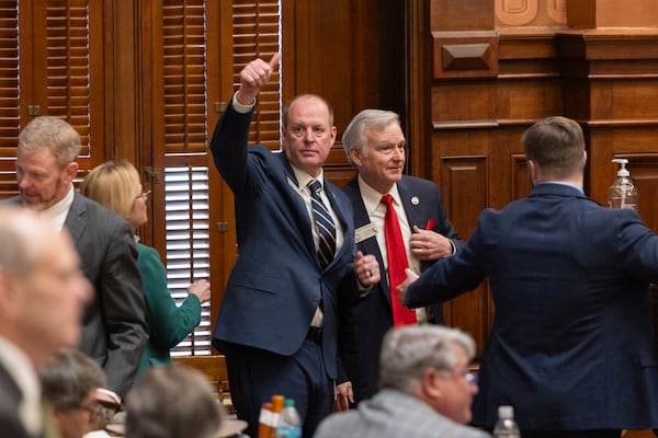 Rep. Holt Persinger, R-Winder, gives a thumbs up following the passage of the school safety bill he sponsored, HB 268, at the House in the Capitol in Atlanta on Tuesday, March 4, 2025. On his right is House Education Chairman Chris Erwin, R-Homer. (Arvin TemkarAtlanta Journal-Constitution via AP)