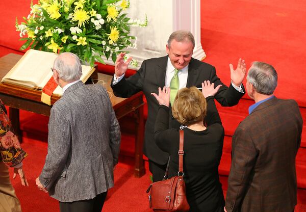 Dr. Dock Hollingsworth, senior pastor, greets his flock at the front of the church after the conclusion of the Palm Sunday service at Second Ponce De Leon Baptist Church in this AJC file photo. 