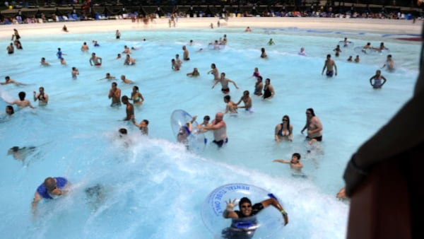 Swimmers are swept by a wave at the new wave pool in Thunder Bay during the the 30th anniversay of the Hyland Hills Water World. Joe Amon, The Denver Post  (Photo By Joe Amon/The Denver Post via Getty Images)