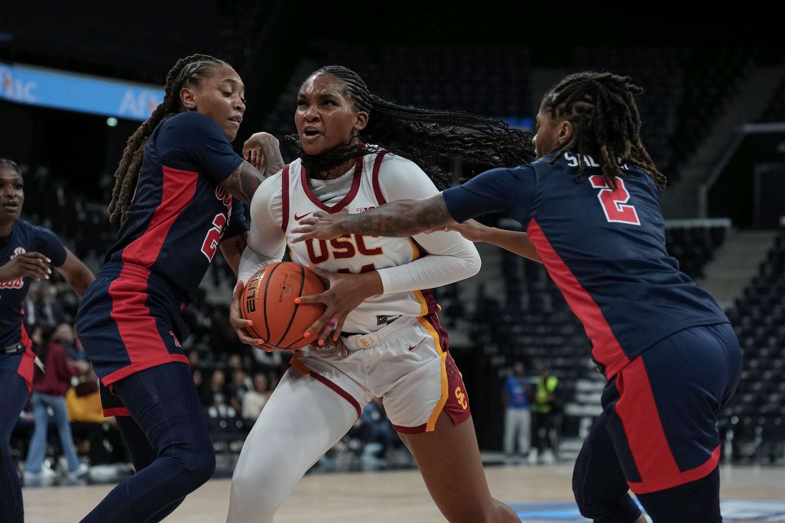 USC forward Kiki Iriafen, center, protects the ball against Mississippi forward Madison Scott, left, and guard Tameiya Sadler, right, during an NCAA college basketball game in Paris, France Monday, Nov. 4, 2024. (AP Photo/Aurelien Morissard)