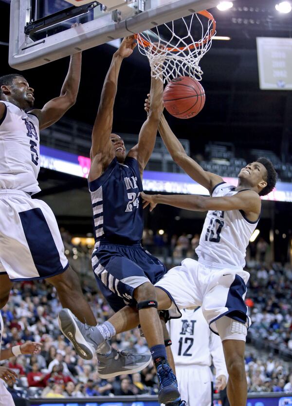 Tift County's P.J. Horne (24) dunks over Norcross's Lorenzo Carter (left) and AJ Farrar (10) in 2014. JASON GETZ / SPECIAL